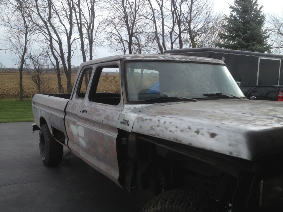1979 Ford F-350 truck, primer finish, four-door cab, front quarter view