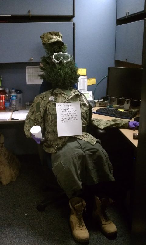 1989 Ford Bronco - A mannequin dressed in military fatigues and a Christmas tree for a head sits at a desk with a note attached.