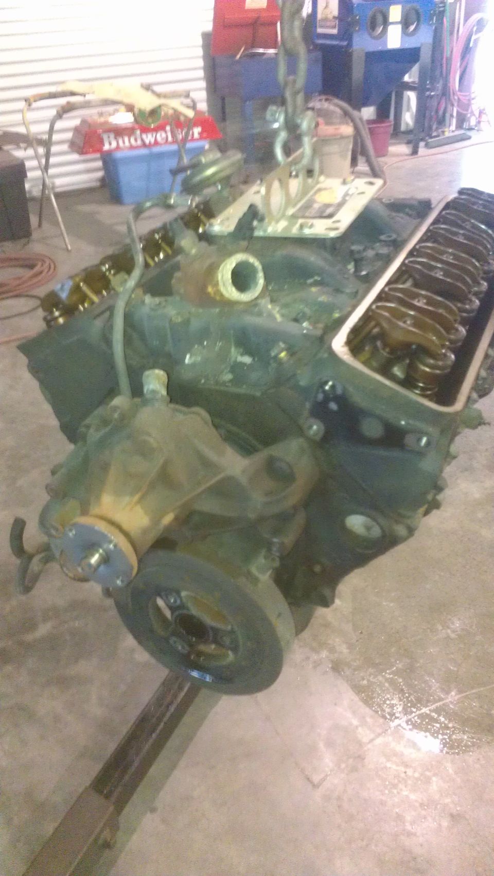 Engine block with water pump and pulley assembly, suspended by chains