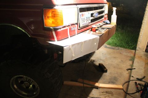 1990 Ford Bronco - A custom bumper is being fabricated and attached to the front of a red Ford truck.
