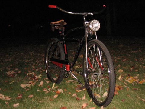 1994 Ford Bronco - A bicycle with a vintage style is shown at night on a lawn covered with autumn leaves.