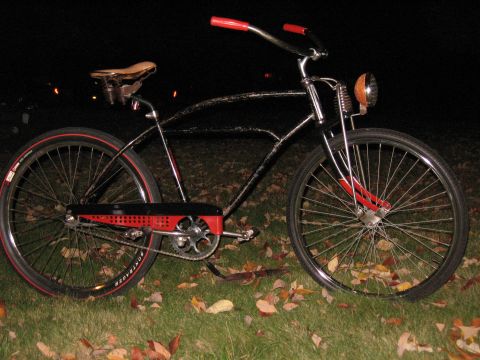 1994 Ford Bronco - A custom bicycle with a vintage aesthetic sits on a grassy lawn at night.