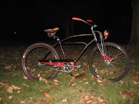 1994 Ford Bronco - A vintage bicycle with chrome frame and red trim sits on a lawn covered in autumn leaves.