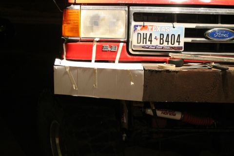 1990 Ford Bronco - Front view of a red Ford truck, possibly from the late 1980s, with a temporary bumper cover and Texas license plate.