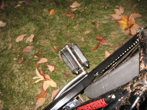 1994 Ford Bronco - A bicycle's pedal and chain are shown resting on grass scattered with autumn leaves.