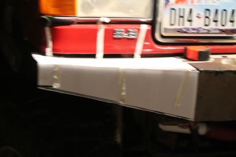1990 Ford Bronco - Close-up of a vehicle's front end, showing a license plate and an emblem.