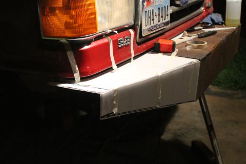 1990 Ford Bronco - Front bumper of a 1990 Ford Bronco with a cardboard mockup taped in place.