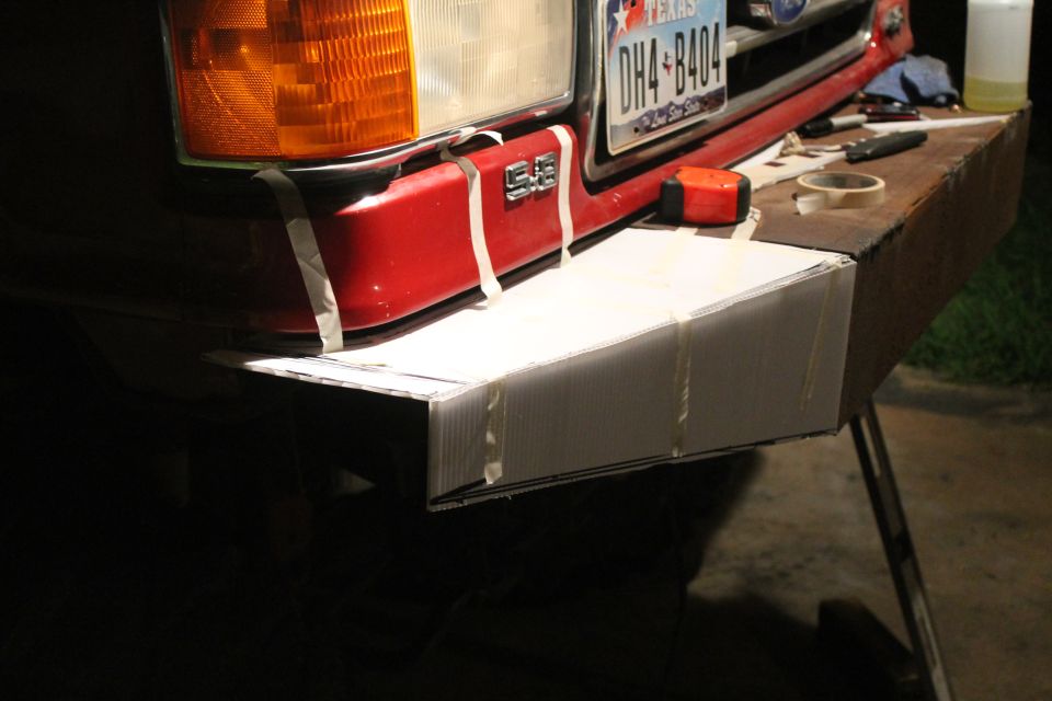 1990 Ford Bronco front bumper with tape holding cardboard mockup