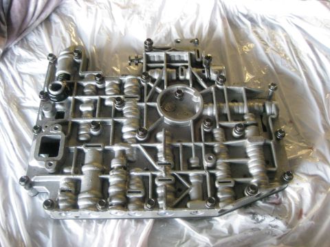 1994 Ford Bronco - Close-up of an automatic transmission valve body, showing its complex internal structure.
