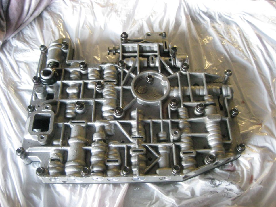 Automatic transmission valve body with numerous screws and internal channels