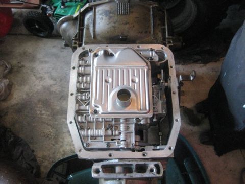 1994 Ford Bronco - The transmission pan is off, revealing the filter and the intricate workings inside the automatic transmission.