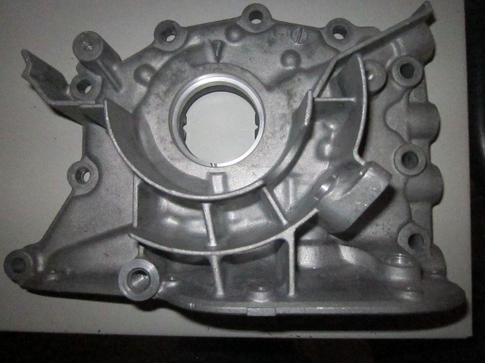 Aluminum engine oil pump housing with circular opening and mounting holes