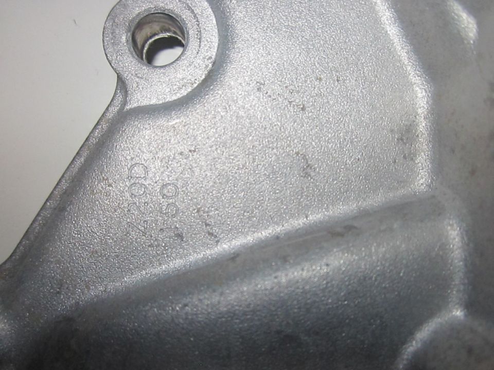 Close-up of a metal part with stamped numbers '7200' and '09 50'