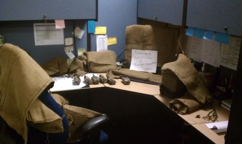 1989 Ford Bronco - A cluttered office cubicle is covered in burlap, with a sign indicating 'Hurricane Condition 4'.