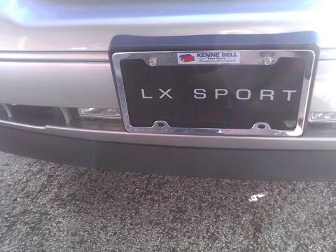 2003 Ford Crown Victoria - The rear bumper of a silver 2003 Ford Crown Victoria LX Sport is visible, with a license plate frame indicating 'LX SPORT'.