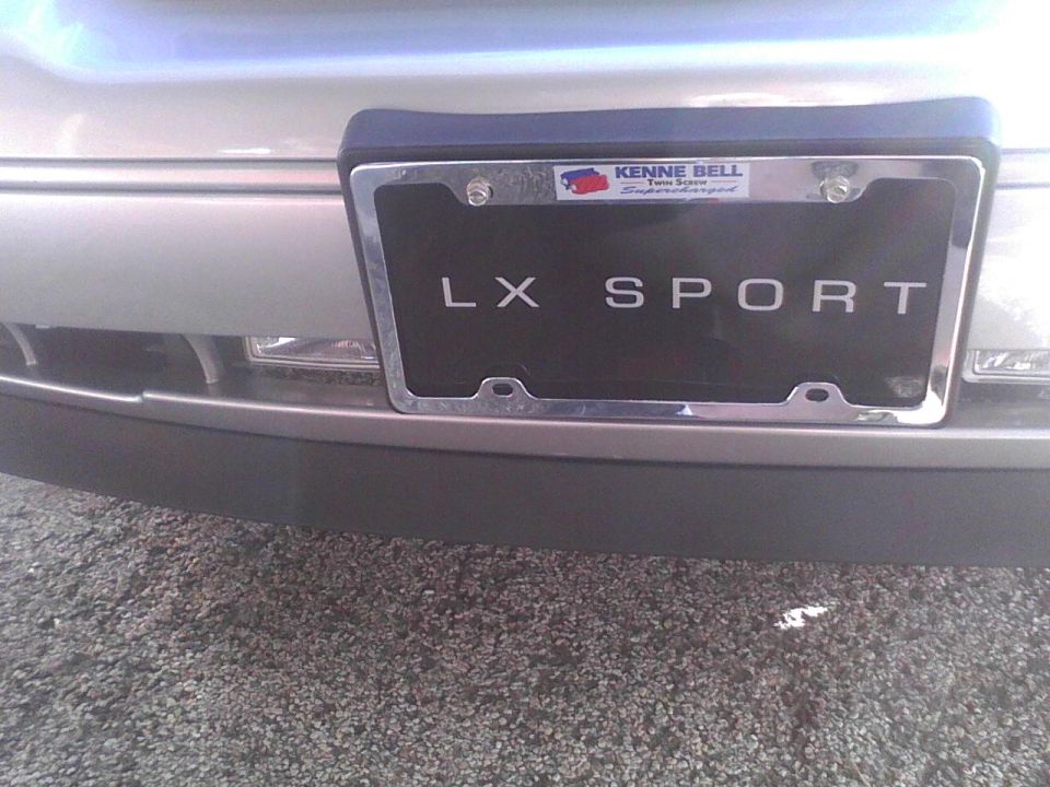 Silver 2003 Ford Crown Victoria LX Sport rear bumper with license plate frame