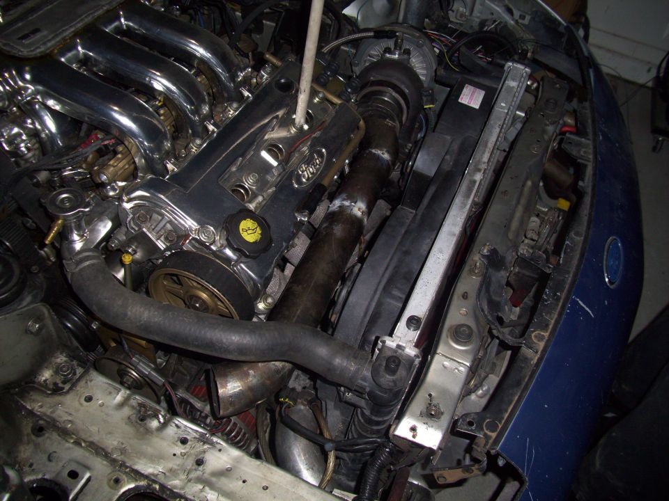 1995 Ford Probe engine bay with chrome intake manifold and turbo piping