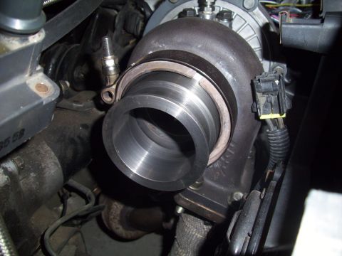 1995 Ford Probe - Close-up view of a turbocharger, showing its metallic components and attached wiring.