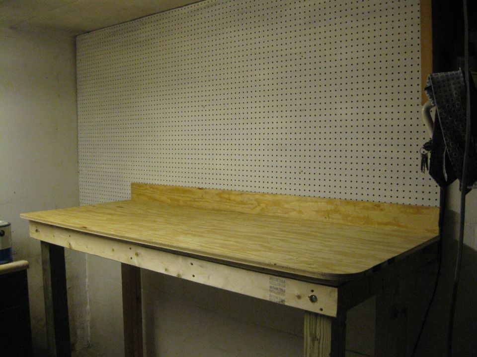 Workbench with pegboard wall and a can on a shelf