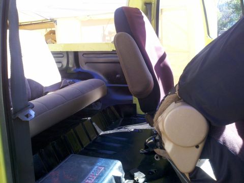 1978 Ford Bronco - Interior view of a vehicle, showing seats and floor. Text on a box reads 'SUPERMOTORS'.