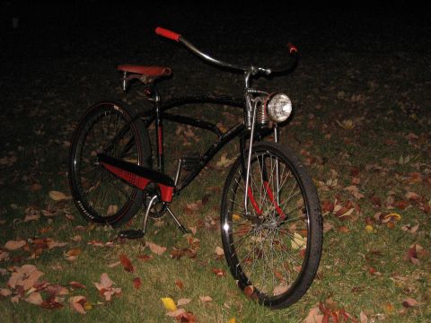 1994 Ford Bronco - A vintage bicycle with a headlight sits on a lawn covered in autumn leaves.