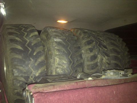 1995 Ford Bronco - Spare tires are stored in the rear of a vehicle, obscuring the view of the vehicle's interior.