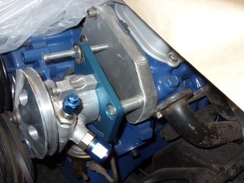 1967 Ford F-250 - Close-up of a power steering pump assembly mounted to a blue engine block.