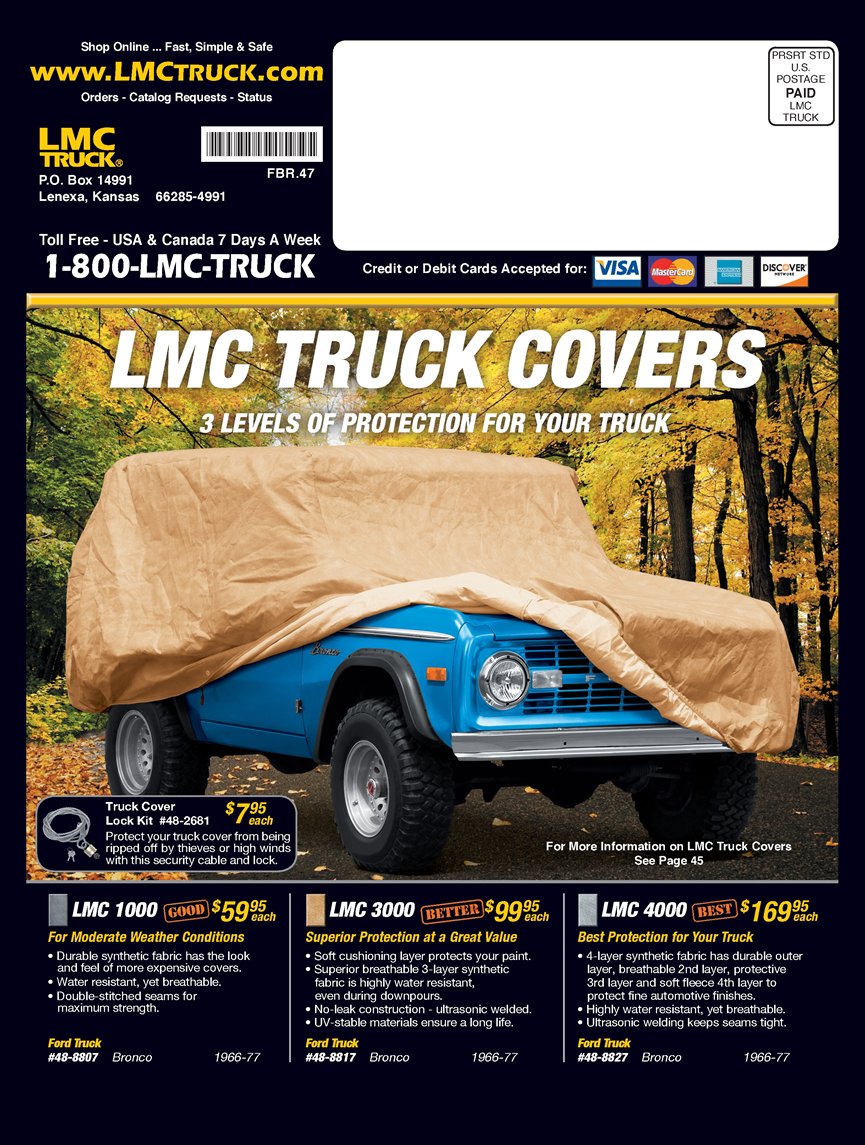 Blue 1976 Ford Bronco covered in a tan car cover, front 3/4 view