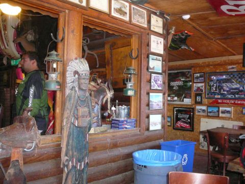 1988 Ford Bronco - A rustic room interior is decorated with a Native American statue, lanterns, and various racing memorabilia.