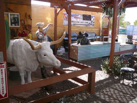1988 Ford Bronco - This scene depicts a longhorn steer statue and a chef figure, set against a backdrop of grills and a 'Welcome Race Fans' sign.