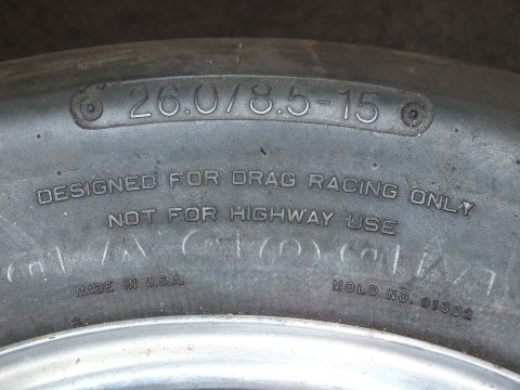2003 Ford Crown Victoria - Sidewall close-up reads 26.0/8.5-15, designed for drag racing only, not for highway use, made in U.S.A., mold no. 91002.