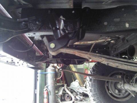 1993 Ford F-150 - The underside of a 1993 Ford F-150 reveals its robust suspension system, including prominent leaf springs.