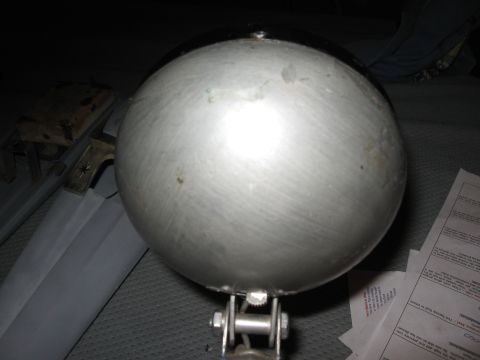 1994 Ford Bronco - A large spherical metal part is shown with mounting hardware and some documents nearby.