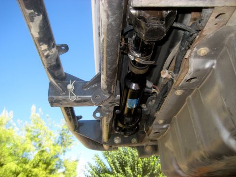 1996 Ford Bronco - Close-up view of the undercarriage of a 1996 Ford Bronco, highlighting the driveshaft and fuel tank assembly.