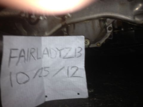 1996 Ford Bronco - A handwritten note with 'FAIRLADYZ 1B 10/15/12' is placed near the undercarriage of a vehicle.