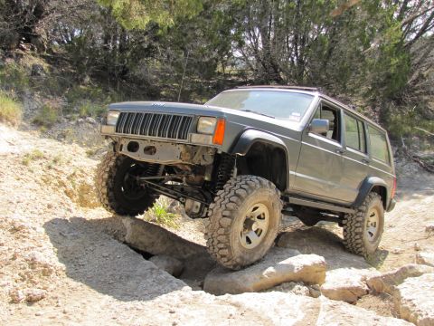 1995 Ford Bronco - Modified Jeep Cherokee XJ tackling a rocky trail during an off-road excursion.