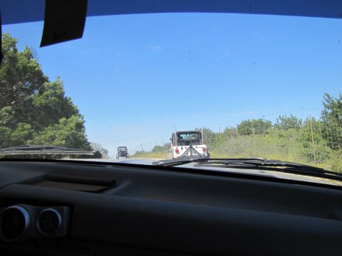 1995 Ford Bronco - Driving behind two Jeeps on a sunny day with clear blue skies.
