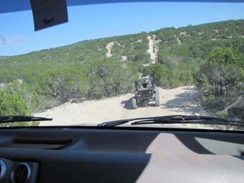 1995 Ford Bronco - Two vehicles on an off-road trail in a wooded, hilly landscape. The date 10-2012 is visible on a note.
