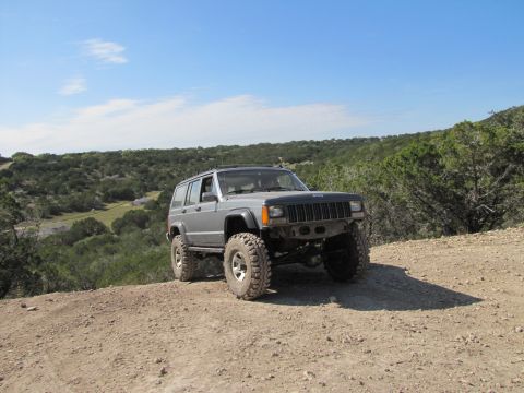 1995 Ford Bronco - This lifted Jeep Cherokee XJ is equipped for off-road adventures on a dusty trail.