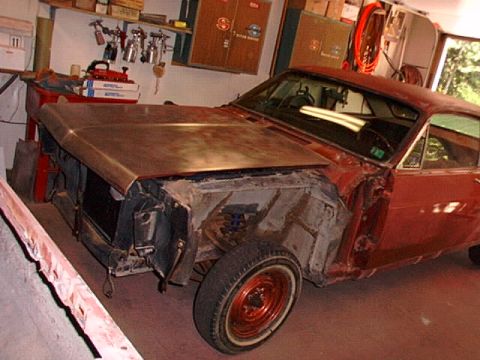 1966 Ford Fairlane - A 1966 Ford Fairlane is shown in a garage, with its front end disassembled for restoration work.