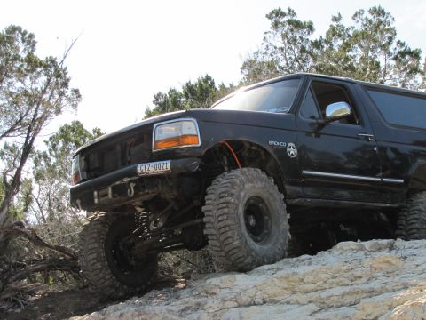 1995 Ford Bronco - This lifted 1995 Ford Bronco navigates a rocky trail, its off-road capabilities.