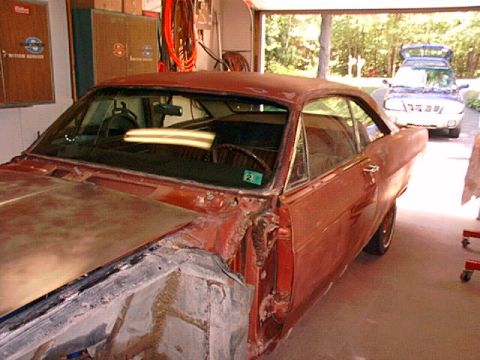 1966 Ford Fairlane - This 1966 Ford Fairlane is in a garage, possibly for restoration, with a blue SUV outside.