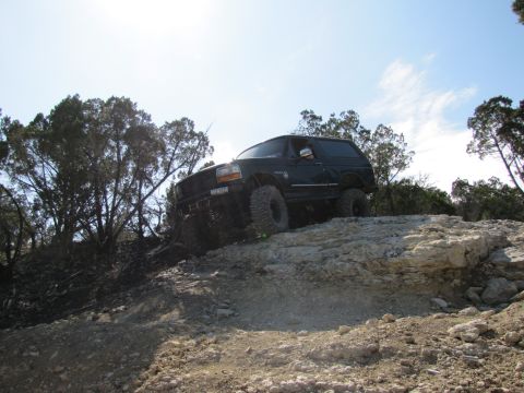 1995 Ford Bronco - Ford Bronco navigating rough terrain during an off-road excursion.