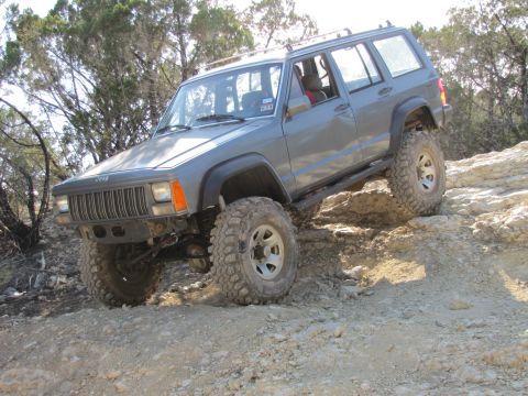 1995 Ford Bronco - This 1995 Ford Bronco is navigating a challenging off-road course with steep inclines and rocky terrain.