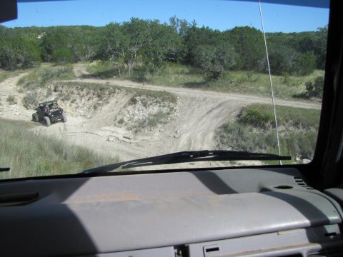 1995 Ford Bronco - View from inside a vehicle looking out at an off-road landscape.