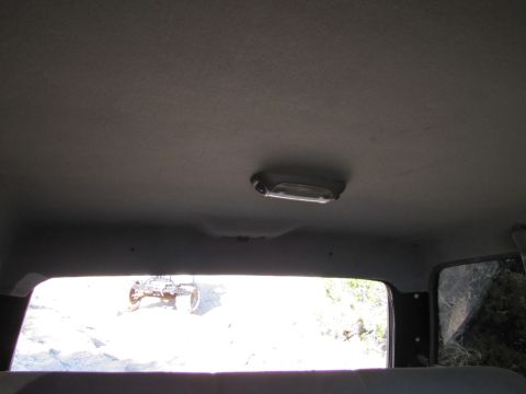 1995 Ford Bronco - Looking out from the interior of a vehicle at an ATV in the distance.