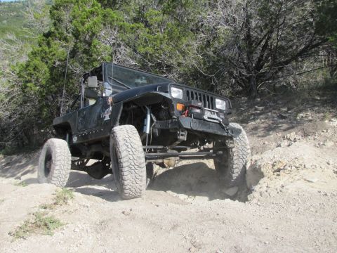 1995 Ford Bronco - This modified Jeep Wrangler navigates a challenging off-road trail.