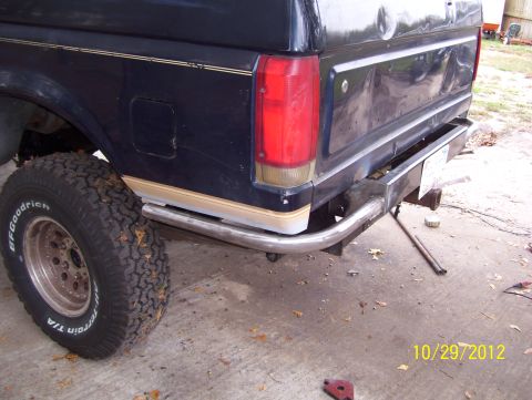 1990 Ford Bronco - Rear view of a 1990 Ford Bronco showing a custom bumper and tire.