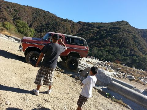 1978 Ford Bronco - This red 1978 Ford Bronco is seen off-roading on a dusty hillside.