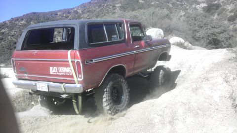 1978 Ford Bronco - This 1978 Ford Bronco is captured in motion on a dusty, off-road path.
